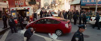 Movie still from “The Other Guys” (2010), directed by Adam McKay – A car that is sitting in the street next to people; Wide shot, High angle