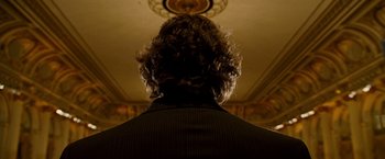 Movie still from “The Other Guys” (2010), directed by Adam McKay – A man in a black suit standing in a room; Close Up shot, Low angle