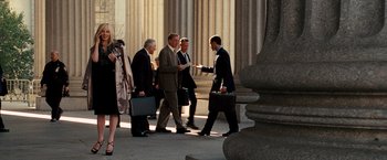 Movie still from “The Other Guys” (2010), directed by Adam McKay – A group of men walking down a sidewalk near a building; Wide shot, Low angle