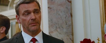 Movie still from “The Other Guys” (2010), directed by Adam McKay – A person wearing a suit and tie; Close Up shot, Over the shoulder angle