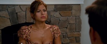 Movie still from “The Other Guys” (2010), directed by Adam McKay – A beautiful woman sitting in front of a stone wall; Close Up shot, Over the shoulder angle