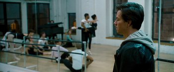 Movie still from “The Other Guys” (2010), directed by Adam McKay – A group of people sitting and standing in a room; Medium shot, Over the shoulder angle