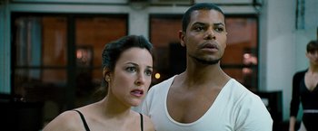 Movie still from “The Other Guys” (2010), directed by Adam McKay – A man and a woman standing next to each other; Close Up shot, Low angle