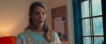 Movie still from “The Other Guys” (2010), directed by Adam McKay – A young woman is standing in front of a calendar; Close Up shot, Over the shoulder angle