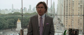 Movie still from “The Other Guys” (2010), directed by Adam McKay – A man wearing a suit and tie standing in front of a window; Close Up shot, Over the shoulder angle