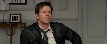 Movie still from “The Other Guys” (2010), directed by Adam McKay – A person wearing a jacket and tie; Close Up shot, Over the shoulder angle