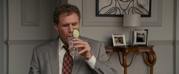 Movie still from “The Other Guys” (2010), directed by Adam McKay – A man in a suit and tie holding a glass of water; Close Up shot, Over the shoulder angle
