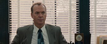 Movie still from “The Other Guys” (2010), directed by Adam McKay – A person wearing a suit and tie; Close Up shot, Over the shoulder angle