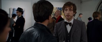 Movie still from “The Other Guys” (2010), directed by Adam McKay – A man in a bow tie talking to another man in a suit; Medium shot, Over the shoulder angle