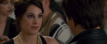 Movie still from “The Other Guys” (2010), directed by Adam McKay – A beautiful young lady sitting next to a group of people; Close Up shot, Over the shoulder angle