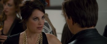 Movie still from “The Other Guys” (2010), directed by Adam McKay – A woman in a black dress talking to a man in a leather jacket; Close Up shot, Over the shoulder angle