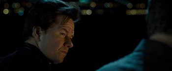 Movie still from “The Other Guys” (2010), directed by Adam McKay – A man's face in the dark; Close Up shot, Over the shoulder angle