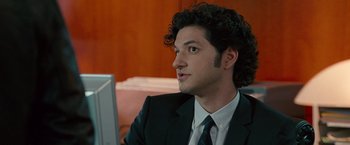 Movie still from “The Other Guys” (2010), directed by Adam McKay – A man in a suit and tie sitting in front of a computer; Close Up shot, Over the shoulder angle