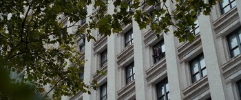 Movie still from “The Other Guys” (2010), directed by Adam McKay – A man is standing on a window ledge of a tall building; Extreme Wide shot, Low angle