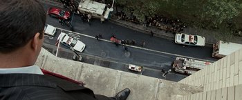 Movie still from “The Other Guys” (2010), directed by Adam McKay – An aerial view of a city street with a fire truck and police cars; Wide shot, Overhead angle