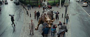 Movie still from “The Other Guys” (2010), directed by Adam McKay – A crowd of people standing next to a statue of a bull; Extreme Wide shot, High angle