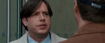 Movie still from “The Other Guys” (2010), directed by Adam McKay – A person wearing a lab coat; Close Up shot, Over the shoulder angle