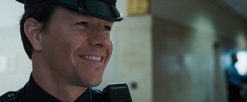 Movie still from “The Other Guys” (2010), directed by Adam McKay – A person wearing a police uniform; Close Up shot, Over the shoulder angle