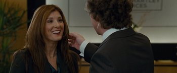 Movie still from “The Other Guys” (2010), directed by Adam McKay – A woman smiling at a man in a suit; Close Up shot, Over the shoulder angle