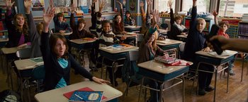 Movie still from “The Other Guys” (2010), directed by Adam McKay – A group of children sitting at their desks raising their hands; Wide shot, High angle