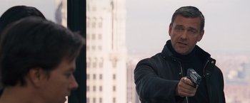 Movie still from “The Other Guys” (2010), directed by Adam McKay – A man standing next to another man in a building; Close Up shot, Over the shoulder angle