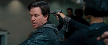 Movie still from “The Other Guys” (2010), directed by Adam McKay – A man is holding a gun up to his head; Close Up shot, Over the shoulder angle