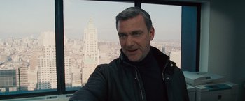 Movie still from “The Other Guys” (2010), directed by Adam McKay – A person with a city in the background; Close Up shot, Low angle