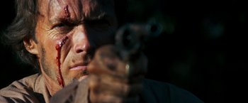 Movie still from “The Outlaw Josey Wales” (1976), directed by Clint Eastwood – A person holding a gun in his hand; Extreme Close Up shot, Low angle