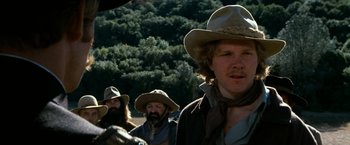 Movie still from “The Outlaw Josey Wales” (1976), directed by Clint Eastwood – A group of men in cowboy hats standing next to each other; Close Up shot, Low angle