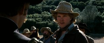 Movie still from “The Outlaw Josey Wales” (1976), directed by Clint Eastwood – A group of men wearing hats and standing next to each other; Close Up shot, Low angle