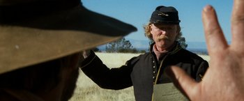 Movie still from “The Outlaw Josey Wales” (1976), directed by Clint Eastwood – A man in a civil war uniform holding a paper; Close Up shot, Over the shoulder angle