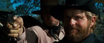 Movie still from “The Outlaw Josey Wales” (1976), directed by Clint Eastwood – Two men in cowboy hats are taking a selfie; Close Up shot, Low angle