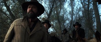 Movie still from “The Outlaw Josey Wales” (1976), directed by Clint Eastwood – A man in a cowboy hat is standing next to another man in a cowboy hat; Close Up shot, Low angle