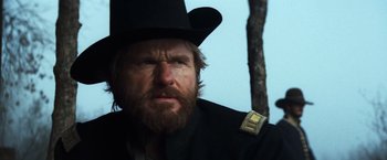 Movie still from “The Outlaw Josey Wales” (1976), directed by Clint Eastwood – A man with a beard wearing a top hat; Close Up shot, Low angle