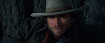 Movie still from “The Outlaw Josey Wales” (1976), directed by Clint Eastwood – A person wearing a cowboy hat; Close Up shot, Low angle