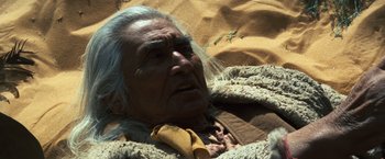 Movie still from “The Outlaw Josey Wales” (1976), directed by Clint Eastwood – An older native american man laying in a bed; Close Up shot, High angle