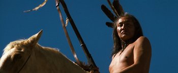 Movie still from “The Outlaw Josey Wales” (1976), directed by Clint Eastwood – A native american man holding a spear in his hand; Close Up shot, Low angle