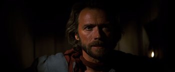 Movie still from “The Outlaw Josey Wales” (1976), directed by Clint Eastwood – A person with long hair and a beard; Close Up shot, Over the shoulder angle