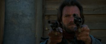 Movie still from “The Outlaw Josey Wales” (1976), directed by Clint Eastwood – A person holding a gun; Close Up shot, Low angle