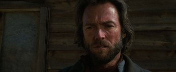 Movie still from “The Outlaw Josey Wales” (1976), directed by Clint Eastwood – A person with a beard; Close Up shot, Over the shoulder angle