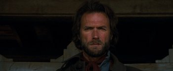Movie still from “The Outlaw Josey Wales” (1976), directed by Clint Eastwood – A person wearing a suit and tie; Close Up shot, Low angle