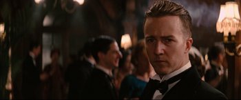 Movie still from “The Painted Veil” (2006), directed by John Curran – A person wearing a suit and tie; Close Up shot, Over the shoulder angle