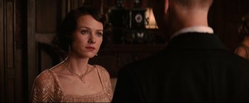 Movie still from “The Painted Veil” (2006), directed by John Curran – A woman in a pink dress looking at a man in a black suit; Close Up shot, Over the shoulder angle