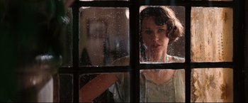 Movie still from “The Painted Veil” (2006), directed by John Curran – A woman looking out of a window through a glass; Close Up shot, Over the shoulder angle