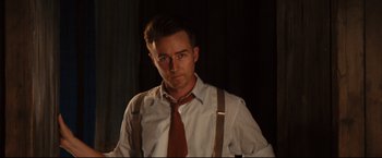 Movie still from “The Painted Veil” (2006), directed by John Curran – A man in a white dress shirt and brown neck tie; Medium shot, Low angle