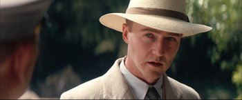 Movie still from “The Painted Veil” (2006), directed by John Curran – A person wearing a suit and a hat; Close Up shot, Low angle