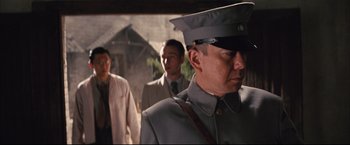 Movie still from “The Painted Veil” (2006), directed by John Curran – A man in a military uniform is walking with other men; Close Up shot, Over the shoulder angle
