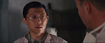 Movie still from “The Painted Veil” (2006), directed by John Curran – A person wearing a suit and glasses; Close Up shot, Low angle