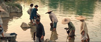 Movie still from “The Painted Veil” (2006), directed by John Curran – A group of people standing in shallow water; Wide shot, High angle