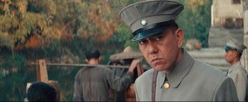 Movie still from “The Painted Veil” (2006), directed by John Curran – A man in a uniform is looking at the camera; Close Up shot, Low angle